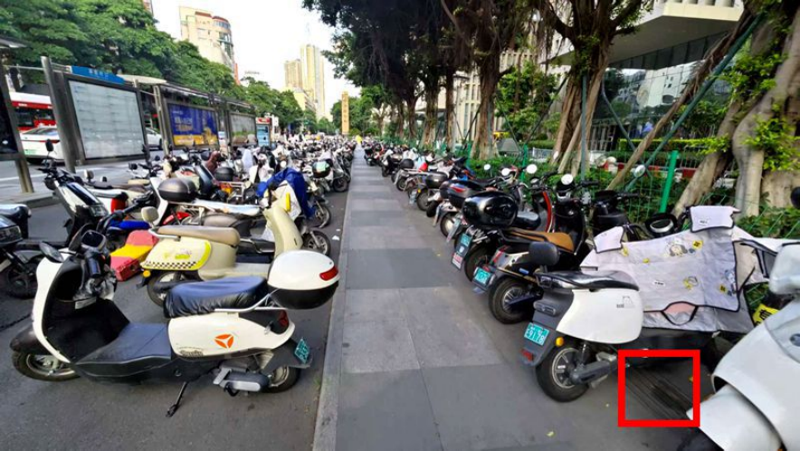 在浦西公交站背后的人行道上，也有不少電動車停放，且完全擋住盲道（紅框位置）。李先生攝于7月6日
